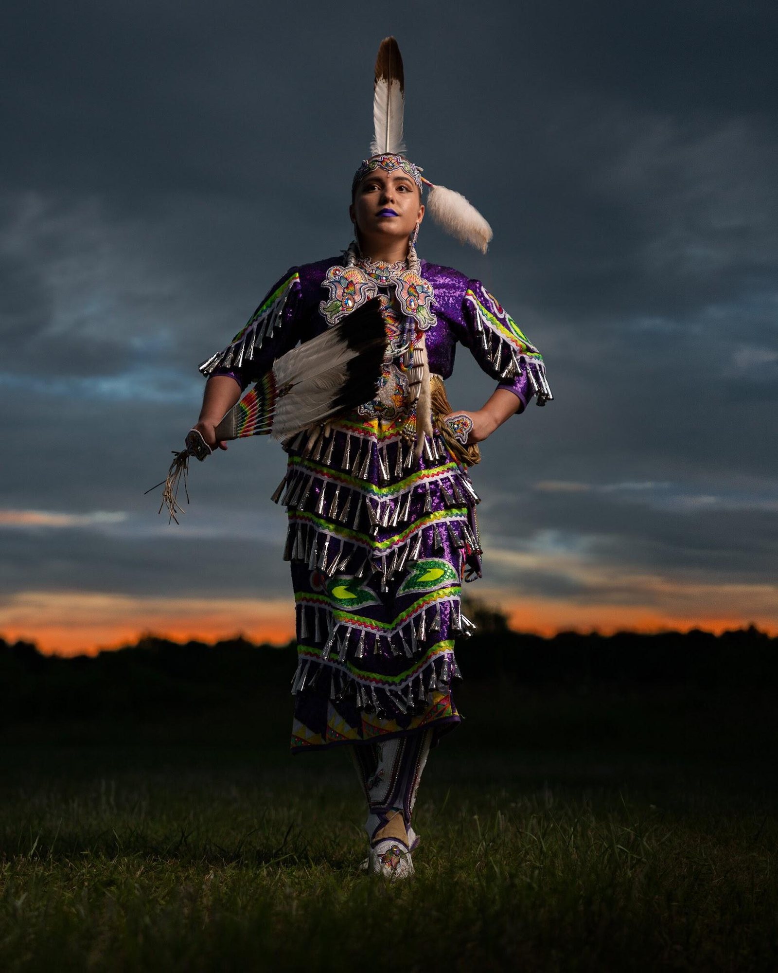 A jingle dress dancer at dusk, photographed by Tomás Karmelo Amaya